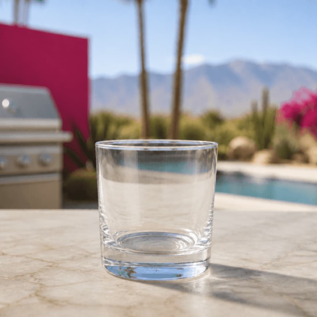 Rocks glass staged on a Palm Springs patio beside a grill and pool