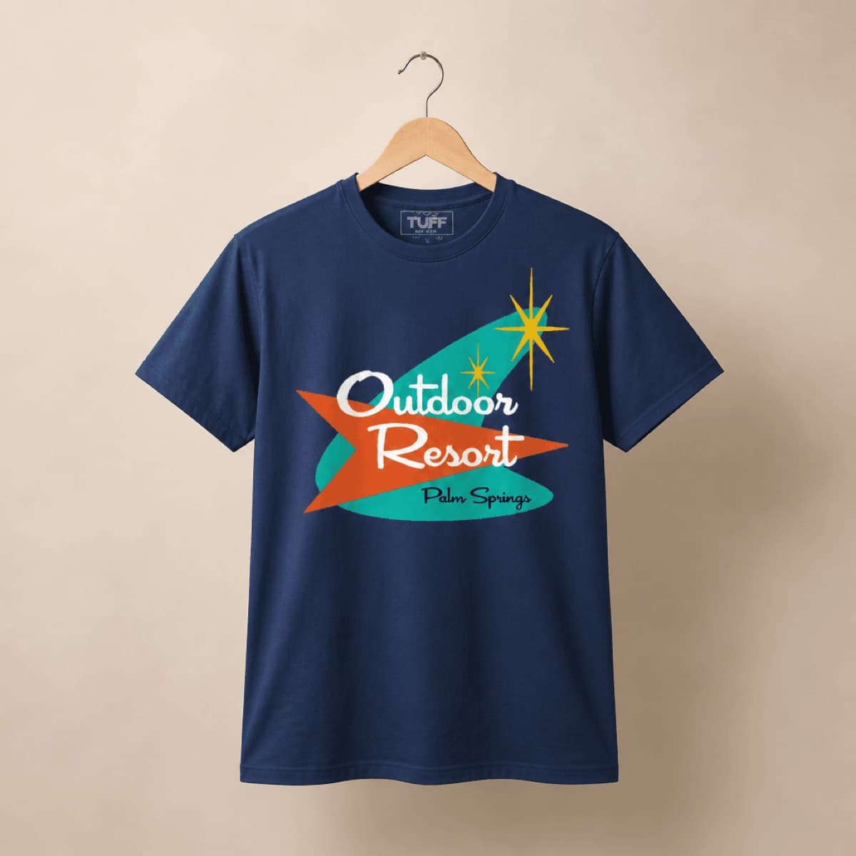 Navy TUFF tee with graphic applied, hanging on a wooden hanger